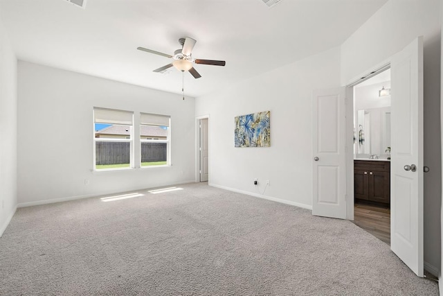 empty room featuring ceiling fan, light carpet, and baseboards