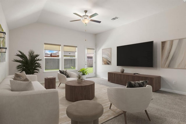 living area featuring a ceiling fan, visible vents, lofted ceiling, and light carpet
