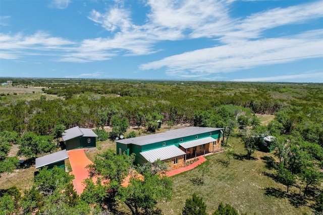 drone / aerial view with a wooded view