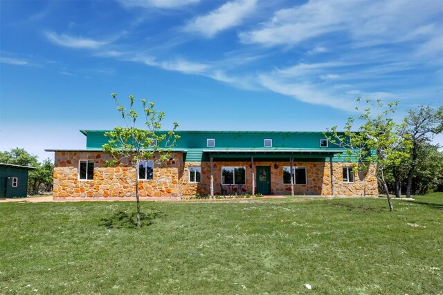 view of front of property with a front lawn and stone siding