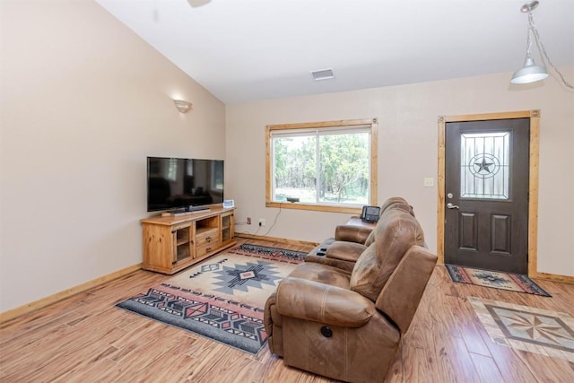 living area featuring wood finished floors, visible vents, and baseboards