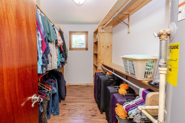 walk in closet featuring wood finished floors