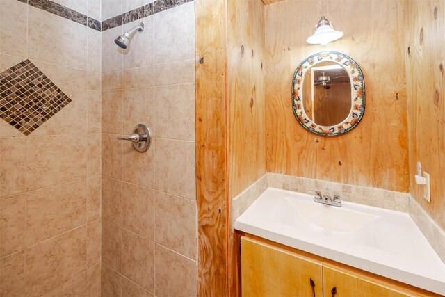 full bathroom featuring vanity and tiled shower