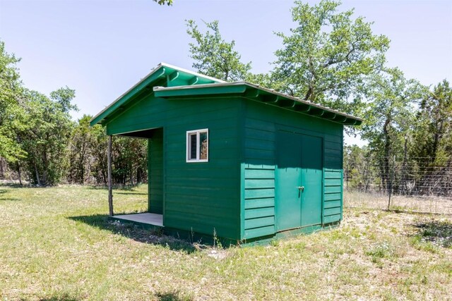 view of shed with fence