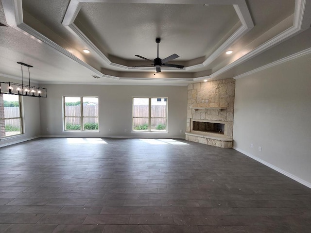 701 Eagle Claw Dr, Salado, TX 76571 - unfurnished living room with a tray ceiling, dark wood finished floors, a ceiling fan, and ornamental molding