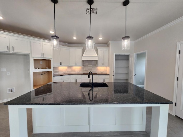 701 Eagle Claw Dr, Salado, TX 76571 - kitchen featuring a sink, decorative backsplash, an island with sink, white cabinetry, and ornamental molding