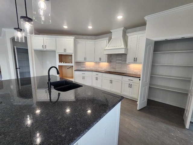 701 Eagle Claw Dr, Salado, TX 76571 - kitchen with black electric stovetop, custom exhaust hood, a sink, and white cabinetry