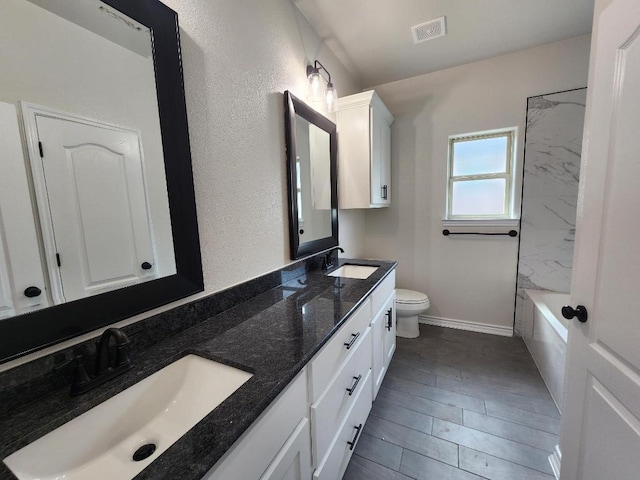 701 Eagle Claw Dr, Salado, TX 76571 - bathroom with visible vents, a sink, double vanity, and toilet