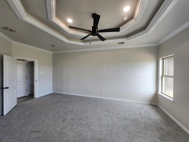 701 Eagle Claw Dr, Salado, TX 76571 - spare room featuring dark carpet, ceiling fan, ornamental molding, and a raised ceiling