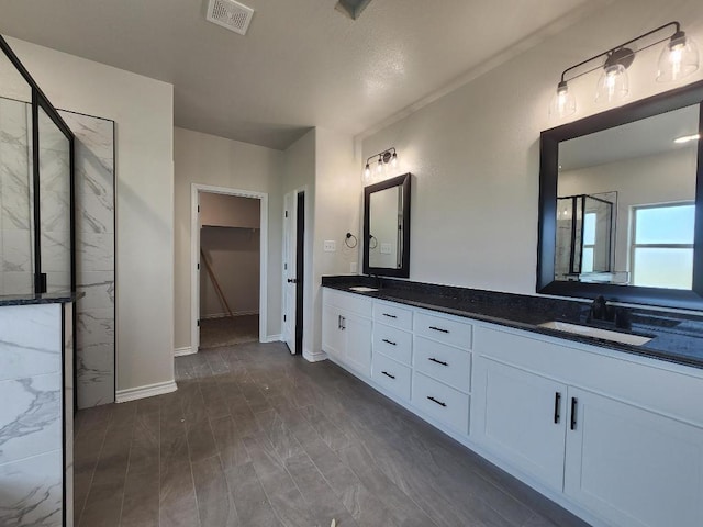 701 Eagle Claw Dr, Salado, TX 76571 - full bath with visible vents, a sink, a walk in shower, and double vanity