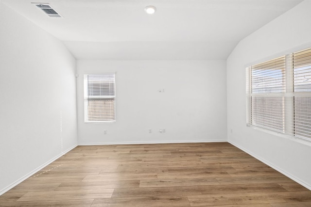 110 Madrid, Kyle, TX 78640 - empty room featuring lofted ceiling, light wood-type flooring, and baseboards