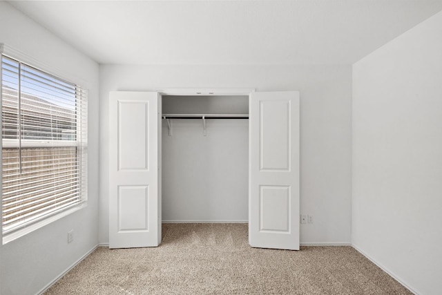 110 Madrid, Kyle, TX 78640 - unfurnished bedroom featuring light colored carpet, a closet, and baseboards