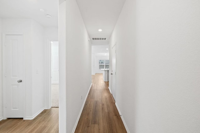 110 Madrid, Kyle, TX 78640 - hallway with wood finished floors, baseboards, and recessed lighting