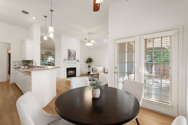 dining area with visible vents, a wealth of natural light, and ceiling fan
