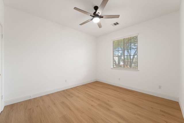 empty room featuring light wood-type flooring, baseboards, visible vents, and ceiling fan