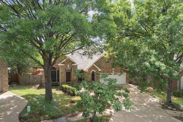 view of front of house with driveway, fence, a garage, brick siding, and a shingled roof