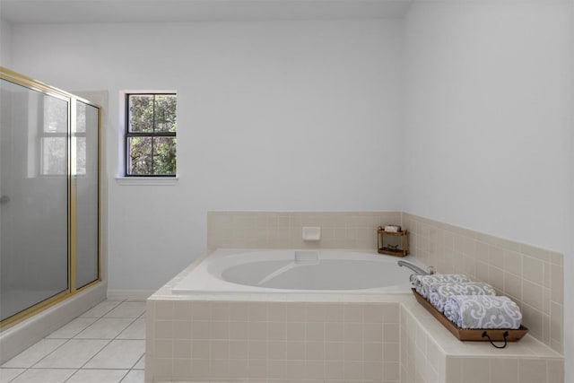 full bathroom with a bath, a shower stall, and tile patterned floors