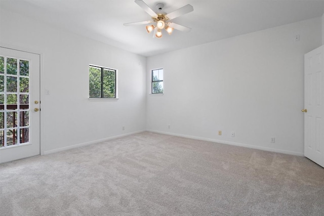 empty room with ceiling fan, baseboards, and carpet flooring