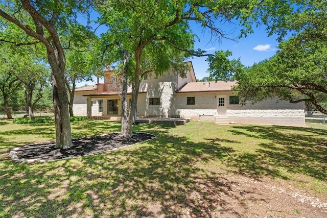 back of house with a lawn