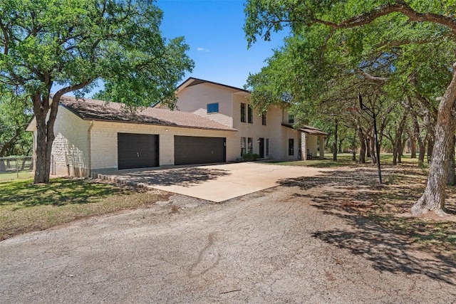 view of front facade with concrete driveway, brick siding, and a garage