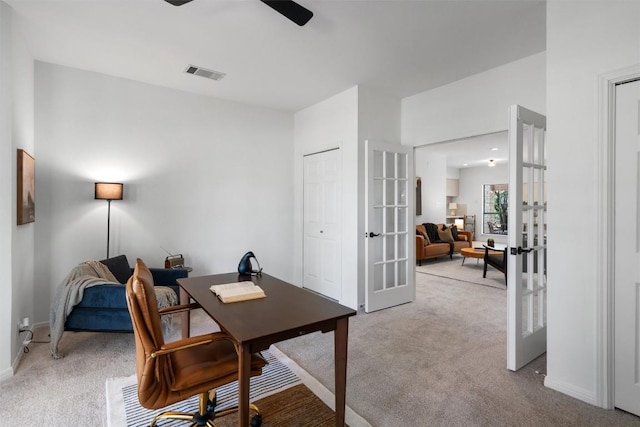 office area with ceiling fan, french doors, visible vents, and light colored carpet