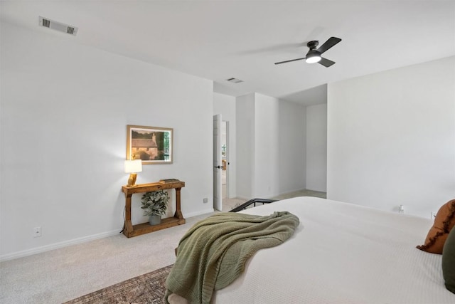 carpeted bedroom featuring baseboards, visible vents, and ceiling fan