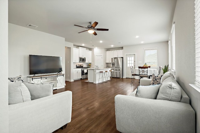 living room featuring visible vents, recessed lighting, ceiling fan, and dark wood finished floors