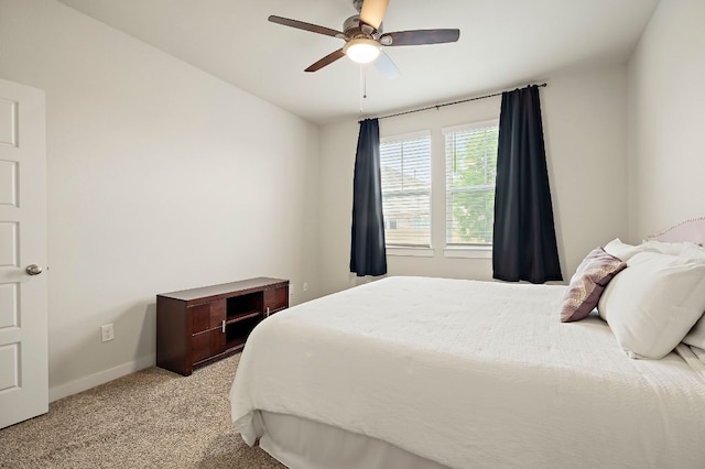bedroom with ceiling fan, baseboards, and light carpet
