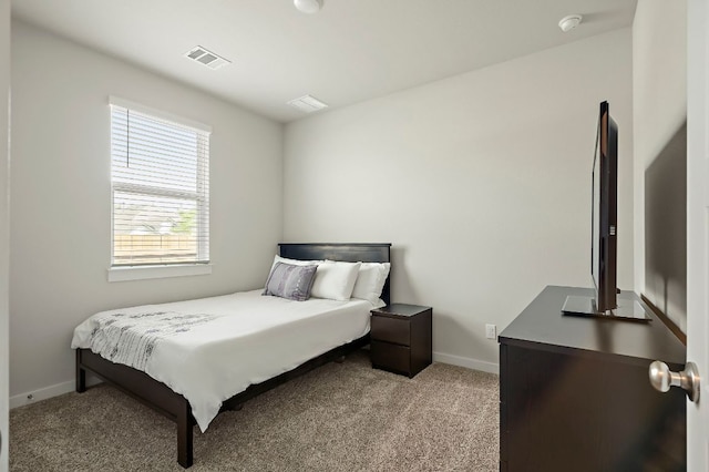 bedroom featuring baseboards, visible vents, and carpet
