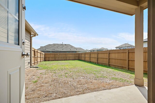 view of yard with a fenced backyard and a patio