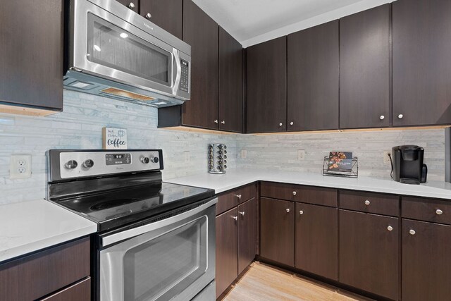 1900 Barton Springs Rd Unit 3007, Austin, TX 78704 - kitchen featuring stainless steel appliances, light countertops, decorative backsplash, and dark brown cabinetry