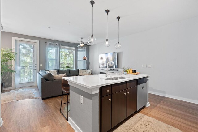 1900 Barton Springs Rd Unit 3007, Austin, TX 78704 - kitchen featuring dishwasher, a sink, light wood-type flooring, and light countertops