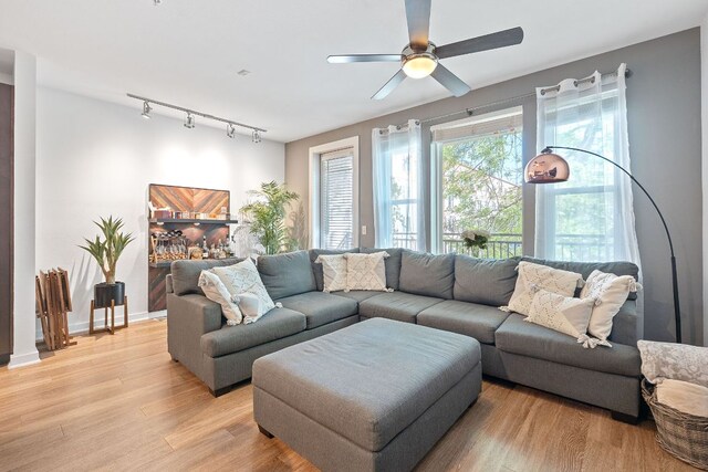 1900 Barton Springs Rd Unit 3007, Austin, TX 78704 - living room featuring track lighting, light wood-type flooring, ceiling fan, and baseboards