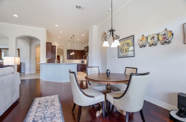 300 Horseback Holw, Austin, TX 78732 - dining area with arched walkways, light wood-type flooring, recessed lighting, and a chandelier