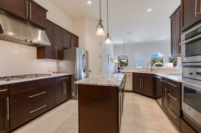 300 Horseback Holw, Austin, TX 78732 - kitchen with appliances with stainless steel finishes, under cabinet range hood, decorative backsplash, dark brown cabinets, and a center island