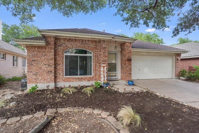 ranch-style house featuring a shingled roof, concrete driveway, brick siding, and a garage