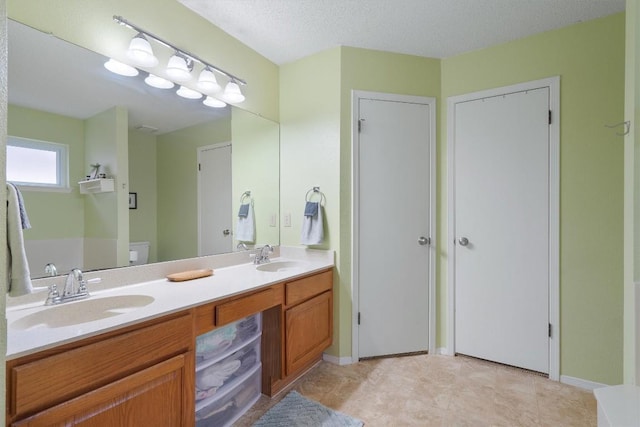bathroom featuring a sink and double vanity