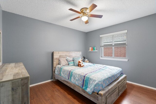 bedroom featuring baseboards, a ceiling fan, and wood finished floors