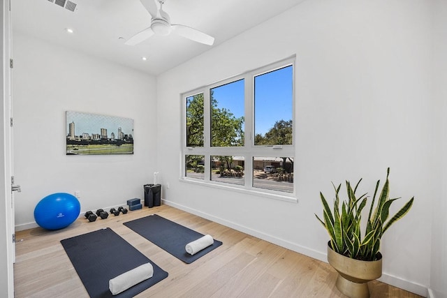 exercise room featuring ceiling fan, baseboards, and wood finished floors