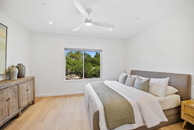 bedroom with recessed lighting, light wood-style flooring, a ceiling fan, and baseboards
