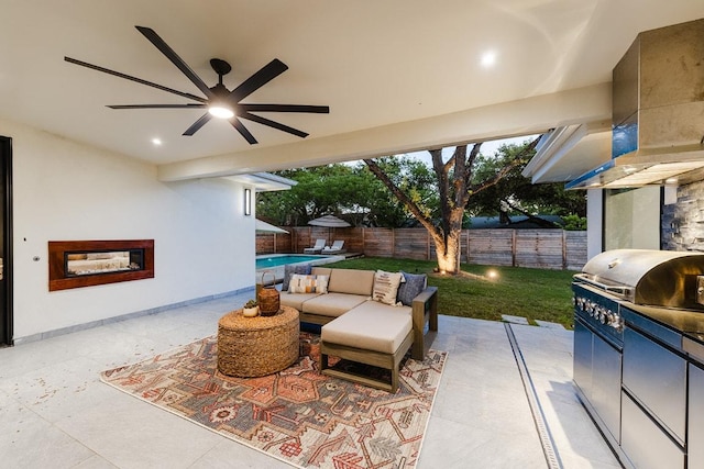 view of patio / terrace featuring ceiling fan, a fenced backyard, and exterior kitchen