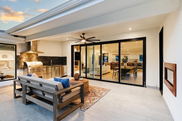 view of patio / terrace featuring grilling area, a ceiling fan, a sink, and exterior kitchen