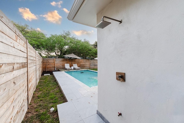 view of pool with a patio area and a fenced backyard