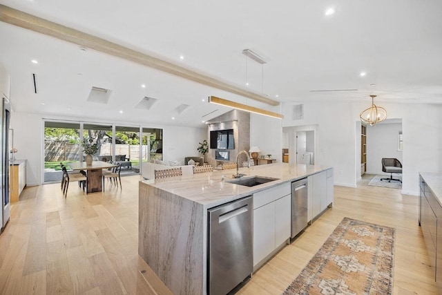kitchen with a large island with sink, dishwasher, modern cabinets, a sink, and open floor plan