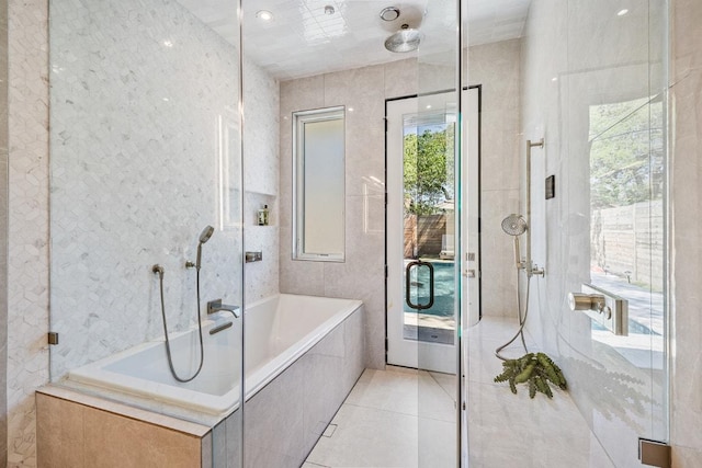 full bath featuring a garden tub, tile patterned floors, and a stall shower