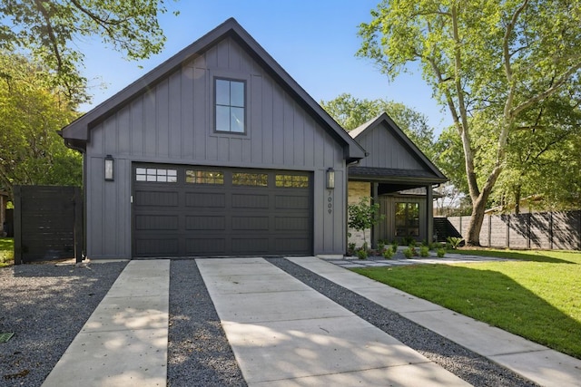 modern inspired farmhouse with board and batten siding, fence, a garage, driveway, and a front yard