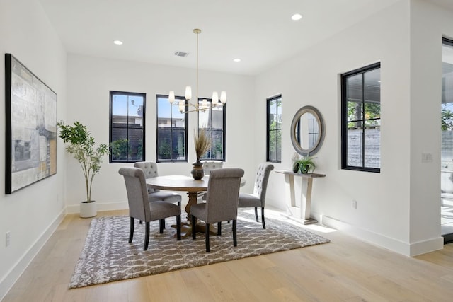dining space featuring visible vents, baseboards, light wood-type flooring, recessed lighting, and a notable chandelier