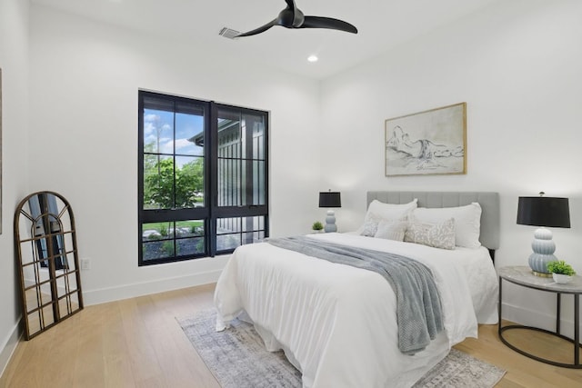 bedroom with baseboards, recessed lighting, wood finished floors, and a ceiling fan