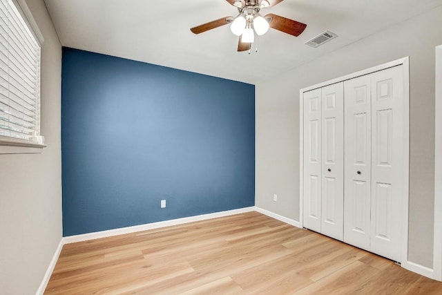 6603 Krollton Dr, Austin, TX 78745 - unfurnished bedroom featuring wood finished floors, a closet, ceiling fan, and multiple windows