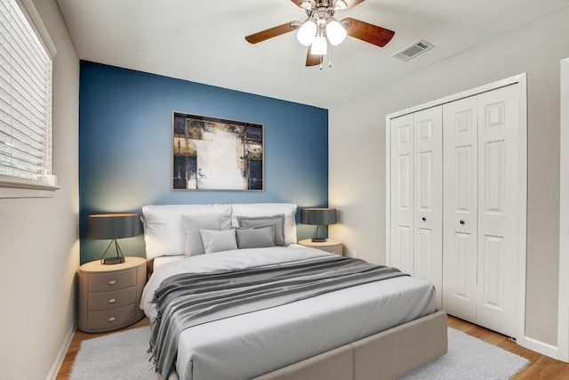 6603 Krollton Dr, Austin, TX 78745 - bedroom featuring baseboards, wood finished floors, a closet, ceiling fan, and multiple windows